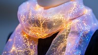 Luminous translucent scarf with golden light particles and cosmic glow effects wrapped around neck creating magical ethereal fashion accessory for fantasy designs.