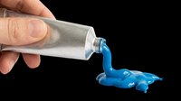 Caucasian hand squeezing blue paint from a silver tube, isolated on transparent background, ready for stickers, clipart, t-shirt design, and print on demand.