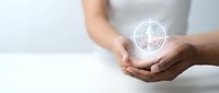 Female hands holding glowing compass symbol representing direction, guidance and navigation in business planning and decision making process.