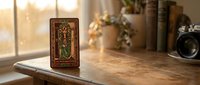 Ornate tarot card with mystical symbols displayed on wooden table near window with warm sunlight creating atmospheric fortune telling scene for spiritual guidance.