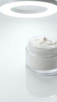 Cosmetic cream or moisturizer in clear glass jar with white lid on bright background, isolated product shot for skincare, beauty, and wellness packaging design.