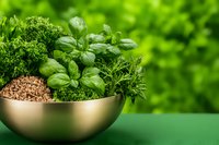 Fresh aromatic herbs and grains in modern gold bowl against green background, featuring basil, parsley and quinoa, styled for healthy cooking and food blogs.