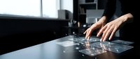 Businesswoman using modern touchscreen interface technology in contemporary office environment for digital workflow and data management solutions.