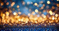Glowing golden bokeh lights on dark blue glittery background create magical festive atmosphere for holiday designs and celebration backgrounds.