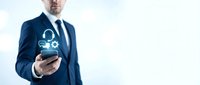 Professional businessman in dark suit holding smartphone with digital security icons and padlock symbols representing cybersecurity and data protection concepts.