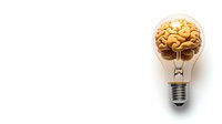 Gold brain inside light bulb on white background, creative concept for innovation, ideas, and intelligence. Minimal composition with copy space.
