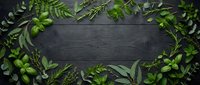 Fresh green herbs and leaves arranged in decorative border frame on dark wooden background with copy space for natural organic cooking design.