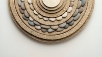 Handwoven jute rope circular wall art with wooden beads in natural boho style for modern home decor and interior design projects.
