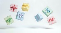 Colorful gift boxes with ribbons floating against white background, perfect for holiday, birthday, celebration, and festive design projects.