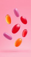 Colorful oval pills floating on pink background. Red, orange and purple medicine capsules falling in creative pharmaceutical composition. Medical concept.