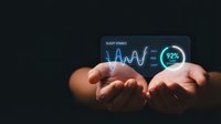 Close-up of hands holding glowing sleep stages data visualization with waveform graph and ninety-two percent metric display on dark background for health monitoring and wellness applications.