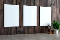 Three blank white vertical frames on dark wooden wall with decorative plant and amber glass bottle on gray surface. Modern minimalist interior mockup.