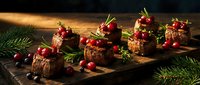 Gourmet chocolate dessert squares topped with fresh cranberries and rosemary on rustic wooden board, perfect for holiday entertaining and festive celebrations.