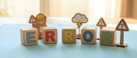 Wooden blocks spelling error with decorative icons including gears, cloud, and warning signs on blue surface with blurred background for web design and technology concepts.