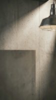 Modern concrete wall with natural sunlight streaming through window creating dramatic shadows and warm lighting atmosphere for interior design projects.