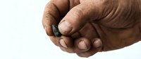 Adult male hands with medium-dark skin tone clasping together in gesture of unity, partnership, or agreement. Suitable for business, teamwork, and collaboration concepts.