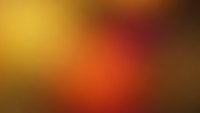 Warm gradient background with smooth color transitions from golden yellow to deep orange and brown tones for modern design projects.