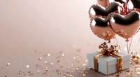 Rose gold heart-shaped balloons with gift box and golden confetti on pink background for Valentine's Day celebration and romantic occasions.