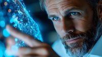 Middle-aged Caucasian businessman analyzing holographic data visualization with blue digital particles and futuristic technology interface for business analytics.