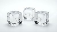 Three crystal clear ice cubes with VIP text engraved on surface, isolated on white background for luxury beverage and hospitality design concepts.