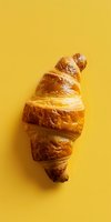 Fresh buttery croissant sliced in creative spiral pattern on vibrant yellow background, perfect for food menu, cafe advertising or culinary blog design.