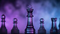 Glass chess king piece stands prominently among other chess pieces with dramatic purple and blue lighting creating strategic business concept atmosphere.