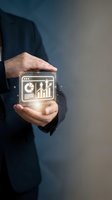 Businessman in dark suit holding glowing digital device displaying analytics charts, pie graphs, and growth icons. Represents data analysis, financial technology, business intelligence, and digital marketing solutions.
