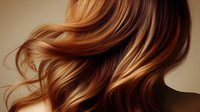 Flowing auburn hair with golden highlights cascades in elegant waves, showcasing natural movement and shine against neutral background.