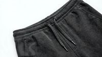 Gray cotton sweatpants with drawstring waistband and elastic cuffs on white background, comfortable casual wear for lounging and athletic activities.