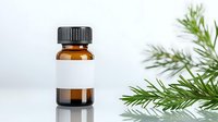 Amber glass essential oil bottle with blank white label next to fresh pine branches on light background, mockup for aromatherapy and natural cosmetic products.