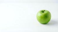 Fresh green apple isolated on white background with copy space for healthy eating and nutrition concepts.