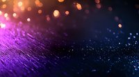 Vibrant purple and blue glowing bokeh lights on dark textured surface with shallow depth of field creating dreamy abstract background for technology designs.