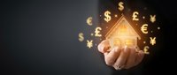 Hand holding glowing house model with floating currency symbols representing real estate investment and property finance concepts for business presentations.