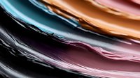 Colorful abstract liquid waves in motion creating smooth flowing lines and gradients from black to turquoise, copper and pink tones. Artistic macro photography.