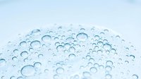 Clear water droplets scattered across clean white surface creating fresh moisture pattern for hygiene and purity concepts in commercial design projects.