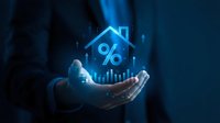 Businessman hand presenting glowing house icon with percentage symbol and upward chart arrows representing mortgage rates and real estate market growth.