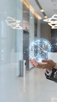 Businessman holding holographic digital globe with network connections in modern office environment representing global business technology and innovation.