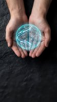 Male hands holding glowing turquoise digital globe with holographic network lines, representing global technology, innovation, and digital connectivity for business and science concepts.