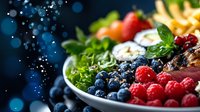 Fresh berries and green salad with grilled chicken breast on white plate against dark background with bokeh lights, healthy eating concept.