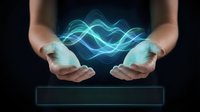 Hands holding glowing blue wave energy light, representing technology, innovation, and digital power for business and science concepts.