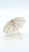 Decorative paper cocktail umbrella with floral pattern and wooden stick on white background for beverage garnish and tropical drink styling.
