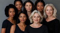 Diverse group of women wearing black tops against gray background showcasing natural beauty, confidence and inclusivity in modern portrait photography.
