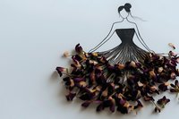 Minimalist fashion illustration combining line drawing of elegant woman in strapless dress with real dried flower petals creating flowing skirt effect on white background.