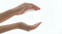 Female hands cupping protective gesture around glowing white orb sphere on clean background for wellness energy healing spiritual concepts.