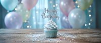 Pastel birthday cupcake with Happy Birthday topper on rustic wood table, surrounded by soft balloons and glitter confetti in dreamy light.
