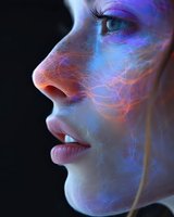 Side profile of young caucasian woman's face illuminated by glowing blue and orange neural network patterns against dark background, representing artificial intelligence and technology.