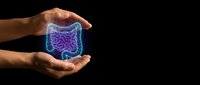 Human hands protecting glowing intestinal tract illustration on black background for healthcare and digestive system medical concepts.