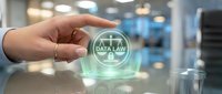 Data law concept with glowing holographic scales of justice held by a hand, symbolizing digital privacy regulations and legal compliance.