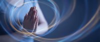 Praying hands surrounded by glowing energy circles and light rays on dark blue background for spiritual meditation and healing concepts.