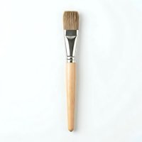 Paintbrush with natural bristles and wooden handle isolated on white background, suitable for art, design, and craft projects.